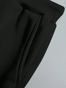 The Stylish And Elegant Simple Round Neck Pullover Sweatshirt Two Pieces Set For Autumn And Winter Features A Thick Flannel Style. The Round Neck Top Is Paired With Drawstring Pants, Showcasing A Fashionable Large Graphic Letter Combination Print Design. It Is Very Suitable For Casual Sports, Fitness Training, Outdoor Jogging, And Daily Wear At Home.