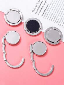 1/2 pièces Crochet de sac créatif, crochet de sac à main, support de rangement pliable, porte-clés portable en alliage, crochet de table. Accessoires de rangement pour sac à la maison. Crochet de rangement portable pour sortie des femmes, crochet pour sac