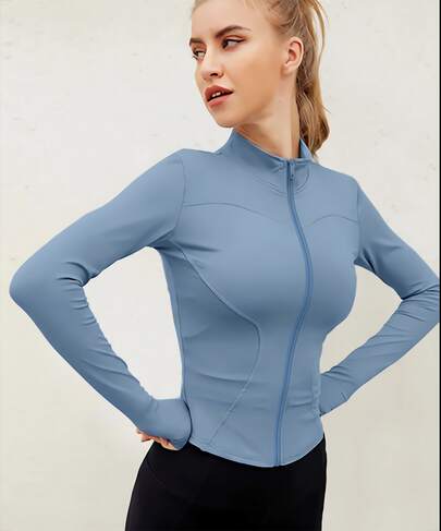 Chaqueta deportiva de manga larga con cremallera de color liso para mujer, corte ajustado y puños con abertura para el pulgar, ideal para fitness, yoga y running.