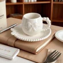 A Set Of Ceramic Coffee Cups And Saucers With Bow-Tie Relief Design (100-180ml Capacity). Perfect For Home Kitchens, Dining Rooms, Or Living Spaces. Each Cup Comes With A Matching Saucer. Ideal For Serving Tea, Coffee, Milk, Water, Or Juice. Suitable For Outdoor Use, Weddings, Parties, Gifting, Or Birthdays.