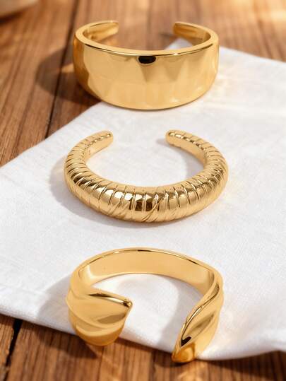 This 3 - Piece Cuff Bracelet Set Showcases Varied Designs: A Polished Wide Bangle, A Textured Ribbed Piece, And A Sleek Sculpted Open Cuff. All Have An Adjustable Fit With A Luxurious Gold Finish.