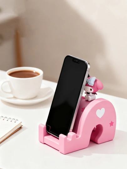 三丽鸥官方授权美乐蒂滑盖手机支架 – 粉色渐变滑盖搭配蓝白蝴蝶结，闭着眼睛，脸颊泛红，饰有星星和爱心，防滑硅胶底座，通用支架兼容iPhone/安卓/平板电脑，尺寸7.4x10x4.5厘米，小巧可爱，是送给女孩、青少年和三丽鸥收藏家的房间装饰和旅行礼物。
