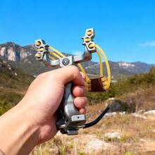 1. Silver Slingshot With An Ergonomic Grip Design, Ideal For Outdoor Adventures And Practice. Features A Wrist Rest, High-Speed Folding Mechanism, Built-In Compass, And Heavy-Duty Rubber Bands For Powerful Elasticity. Practical And Convenient. - 1pcs - View 5