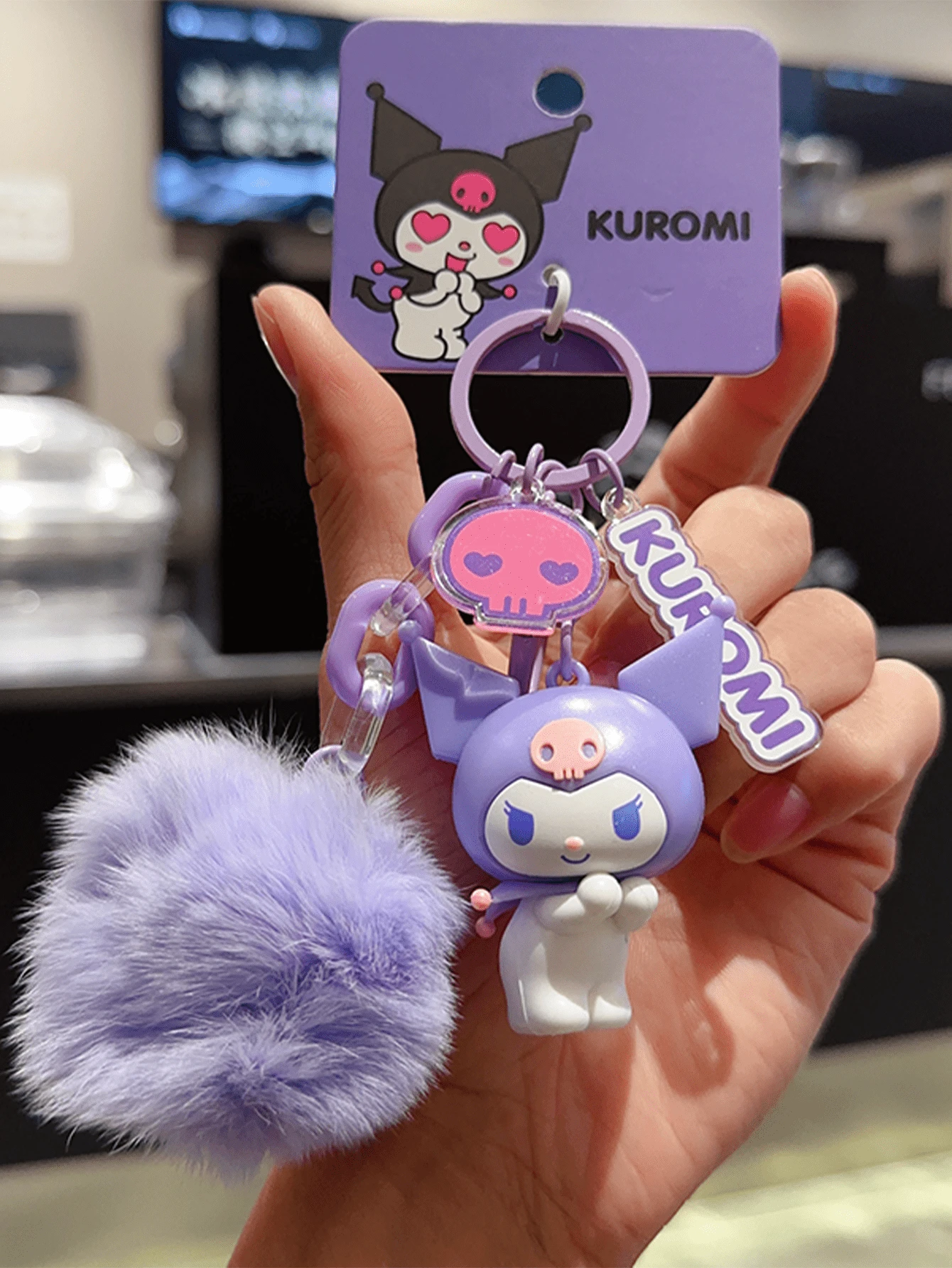 Sanrio Kuromi Keychain with Purple Pom Pom – Adorable 3D Cartoon PVC Keyring for Bags, Backpacks, Car Keys or Purses, Cute Fuzzy Pom Pom Accessory, Stylish Purple Series Design for Teens, Youth, Pop Culture Fans & Sanrio Collectors. Special Occasion Gift, Stylish Kawaii Cartoon Must-Have