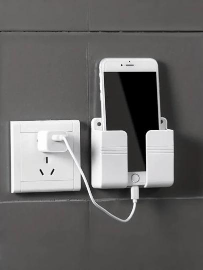 1 st. Telefoonhouder voor aan de muur | Geen boren nodig | Opbergruimte voor afstandsbediening | Zelfklevend materiaal | Kunststof materiaal | Inclusief smartphone-oplaadfunctie