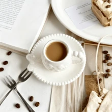 A Set Of Ceramic Coffee Cups And Saucers With Bow-Tie Relief Design (100-180ml Capacity). Perfect For Home Kitchens, Dining Rooms, Or Living Spaces. Each Cup Comes With A Matching Saucer. Ideal For Serving Tea, Coffee, Milk, Water, Or Juice. Suitable For Outdoor Use, Weddings, Parties, Gifting, Or Birthdays.