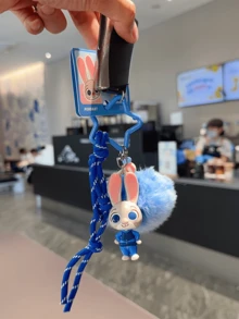 正版授权朱迪·霍普斯系列彩色胡萝卜吊坠，Q版朱迪造型，饰以浅蓝色大绒球、深蓝色编织绳和星形金属环，采用柔软乙烯基材质制成，非常适合挂在钥匙、包包上或作为桌面装饰，带来愉悦心情。是送给粉丝、爱人、学生、青少年、收藏家的理想礼物，也是送给爱人/朋友的贴心之选。