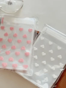 100个透明心形自粘包装袋，适用于饼干、糖果和甜点，也适合礼品和纪念品包装，是情人节、婚礼和其他庆祝活动的理想之选。 - 彩色 - 查看 8