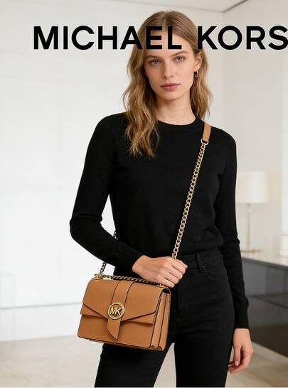 Michael Kors GREENWICH Small Crossbody Bag, Light Blue 32S1GGRC0L457. Fashionable Leather Flap Design With A Unique Circular Metal Logo, Spacious Interior, And A Chain Shoulder Strap, Making It An Ideal Choice For Elegant Attire.