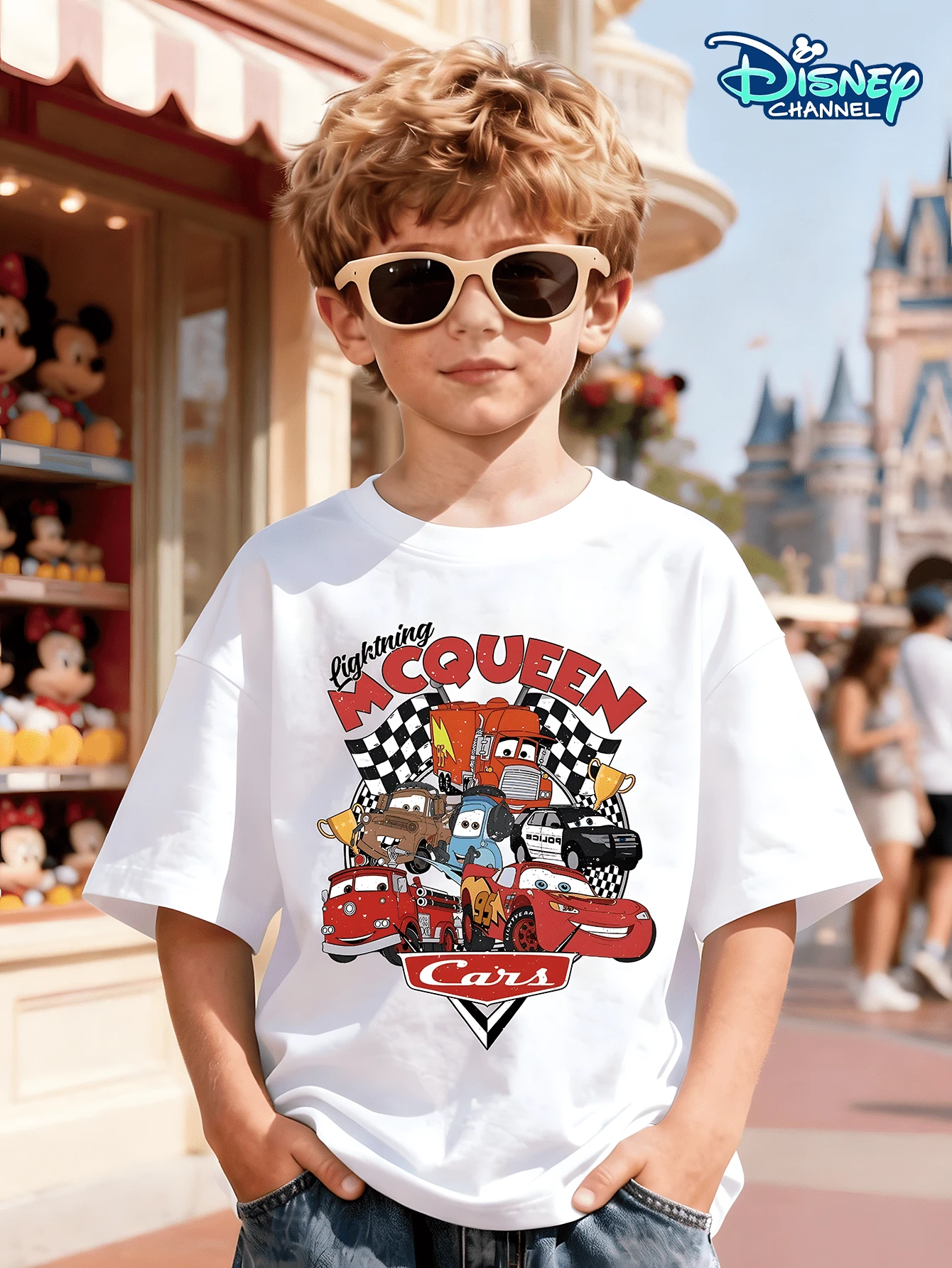 This White Short-Sleeved T-Shirt For Boys Aged 3-12 Features A Cars-Themed Print On The Front, With "Lightning McQueen" In Red Artistic Lettering At The Top. The Main Design Includes Images Of Lightning McQueen, Mater, Sally, And Other Characters' Cars, Set Against A Black And White Checkered Racing Flag Background. The Bottom Displays The "Cars" Logo. It Can Be Paired With Wide-Leg Jeans, Cargo Shorts, Casual Sweatpants, Or Athletic Joggers, Making It Suitable For Various Occasions Such As Disneyland Visits, Family Outings, School Days, Outdoor Parties, And Racing-Themed Events, Meeting The Needs Of Boys For Both Everyday Wear And Themed Activities. - White - View 1