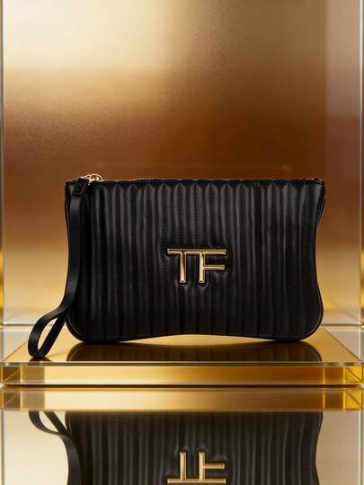 Tom Ford Svart sminkväska. Sminkväska med elegant lång handledsrem. Raffinerad randig förvaringsväska. Anpassningsbar.