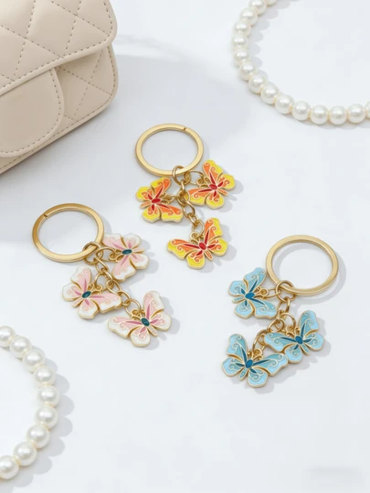 1 stuk kleurrijke vlinder emaille sleutelhanger, veelkleurige bloemen tashanger voor rugzakken en handtassen, uniek verjaardagscadeau, cadeau voor de start van het schooljaar, Halloween of Kerstmis, een schatcadeau voor een speciaal iemand, een bedankje voor vrouwen en mannen, ideaal voor verpleegkundigen, leraren en mentoren, schattige tasaccessoire met ID-kaartkoord en hanger voor auto-onderdelen.