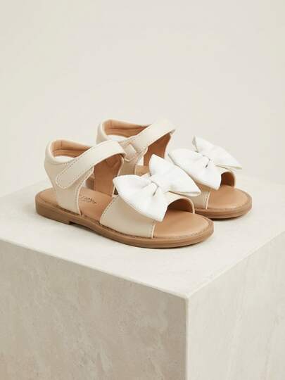 3-12 Years Old Girls' White Ribbon Sandals - Made Of Pure White Synthetic Leather With 3D White Ribbon, Open Toe With Hook And Loop Ankle Strap, Light Beige Insole + Light Brown Non-Slip Rubber Sole. Gentle And Sweet Fresh Style. Suitable For Daily Casual Wear Or Warm Celebration Occasions. Perfect For Spring And Summer Seasons!