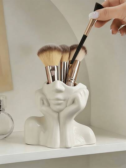 1 件装旗舰款化妆刷收纳架，独特的人形设计，双手托腮，完美适用于桌面和梳妆台收纳，兼具装饰性和实用性，是存放美妆工具的理想之选，可用于收纳化妆刷和美容配件，也可作为浴室或卧室的桌面装饰品。