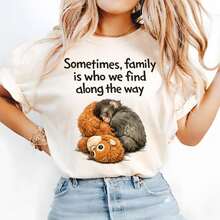 Warm And Realistic Style T-Shirt With A Little Gorilla Cuddling With A Plush Toy While Sleeping Print. Sometimes, Family Is Who We Find Along The Way Text Design. Suitable For Everyday Casual Wear. A Warm, Soothing, Gentle, Heartwarming, Cute, Soft And Adorable Healing Top - White - View 1