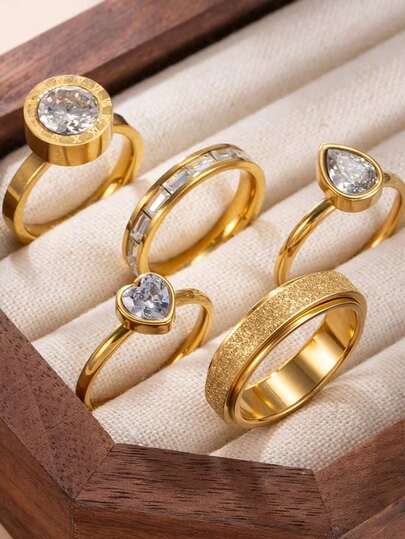 Set de 5 anillos de acero inoxidable con tono dorado para mujeres, incluye elementos de números romanos mate, circonita cúbica y gota de agua con rhinestone, adecuado para uso diario y accesorios festivos