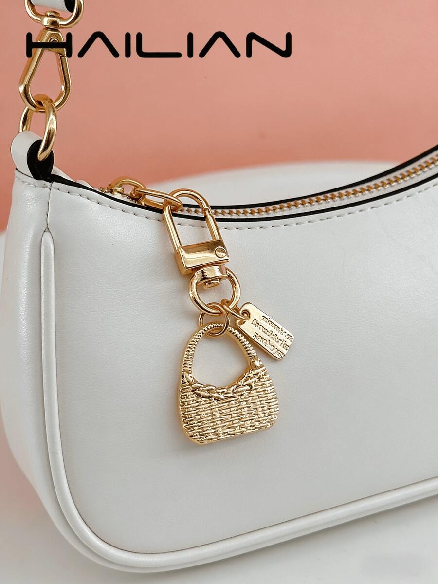 HAILIAN An Alloy Bag Charm Designed In The Style Of A Shoulder Bag, Featuring A Small Square Pendant Inscribed With A Spell. It Serves As A Versatile Accessory-Perfect As A Bag Charm, A Car Key Chain, Or A Small Festive Gift. - Gold - View 1