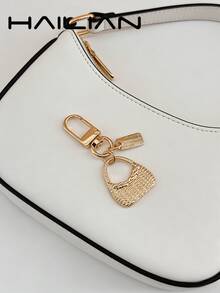 HAILIAN An Alloy Bag Charm Designed In The Style Of A Shoulder Bag, Featuring A Small Square Pendant Inscribed With A Spell. It Serves As A Versatile Accessory-Perfect As A Bag Charm, A Car Key Chain, Or A Small Festive Gift. - Gold - View 2
