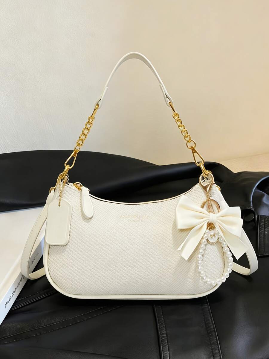 Túi đeo vai nữ kiểu dáng cổ điển mới, được làm từ chất liệu PU chống thấm nước đa năng, trang trí bằng nơ và mặt dây chuyền ngọc trai, in họa tiết chữ cái. Túi có thể đeo vai hoặc đeo dưới cánh tay, phù hợp cho mua sắm, đi làm, đi chơi và các dịp dự tiệc. - Màu be - Xem 1