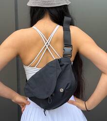 Lululemon Curved Crossbody Bag 3L | Ergonomic Half-Moon Silhouette | Water-Repellent High-Density Nylon | Interior Organization Pockets | Adjustable Strap For Custom Fit | The Ultimate Minimalist Essential - Black - View 2