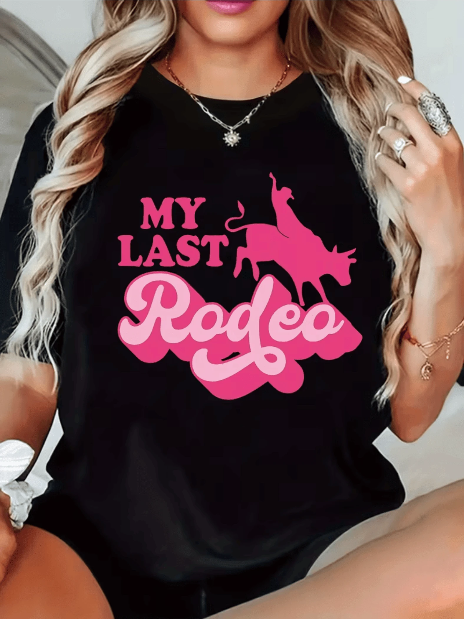 A Figure Of A Brave Rider On A Bull, Symbolizing Strength, Determination, And Feminine Freedom, With Large, Bright Pink Lettering, Is Featured On This Modern, Comfortable, Casual Women's T-Shirt, Perfect For Everyday Wear. - Black - View 1