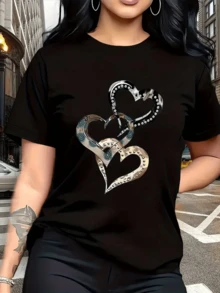 Intertwined Hearts Decorated With Metallic Shapes And Circular Details Symbolize Unity, Strength, And Elegance, Reflecting A Deep And Modern Connection. Casual Women's T-Shirt For Everyday Wear. - Hitam - View 1