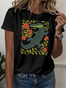 Cocodrilo verde rodeado de flores naranjas que simbolizan fuerza vital y equilibrio natural en conexión con la tierra camisetas de mujer casual moderna cómoda para uso diario - Negro - Ver 6