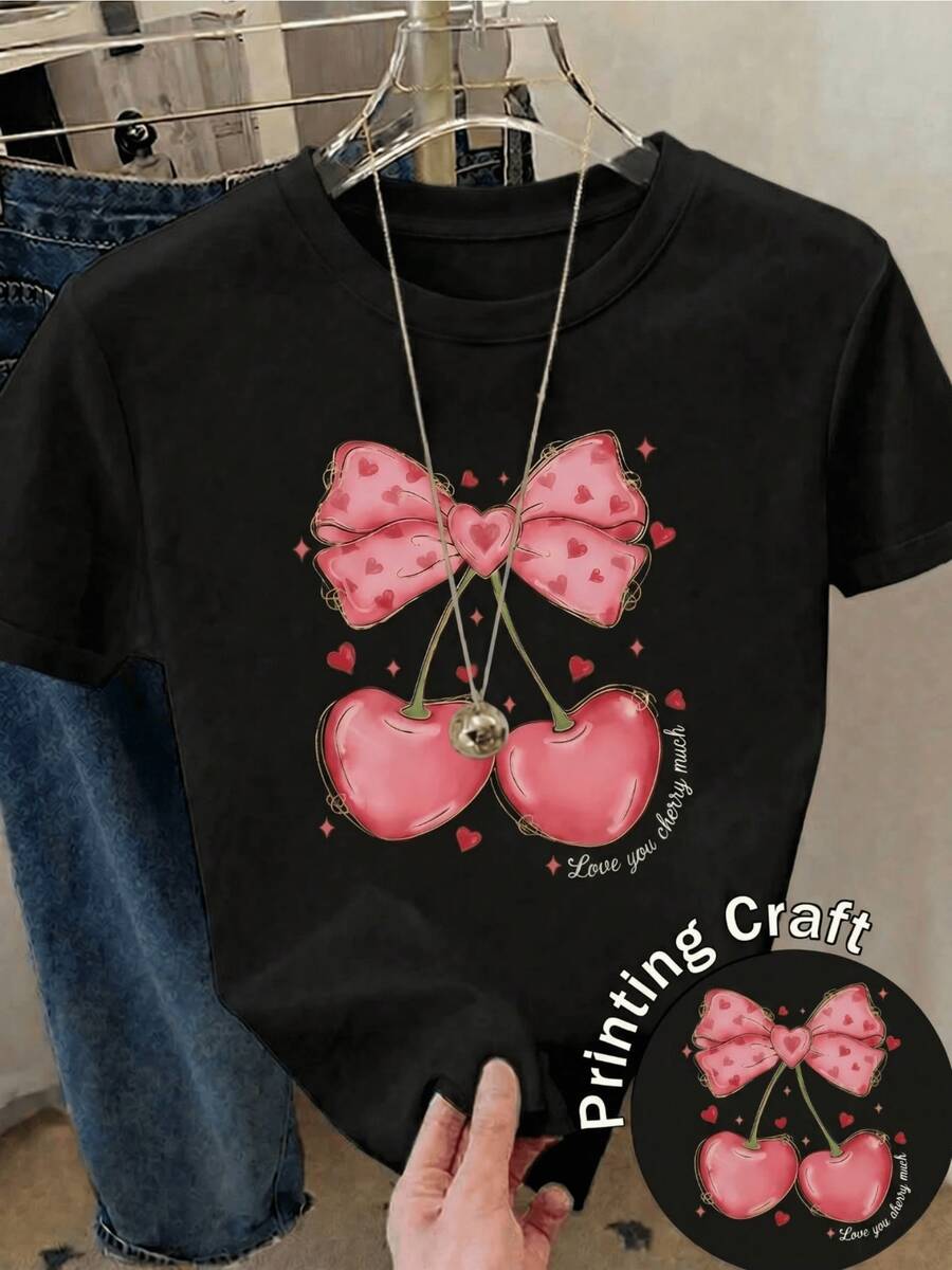 Two Sweet Cherries Joined By A Pink Ribbon With Small Hearts Symbolize Tenderness, Youth, And Sincere Love With A Romantic And Cheerful Touch. Comfortable Casual Women's T-Shirt For Everyday Wear - 黑色 - 查看 1