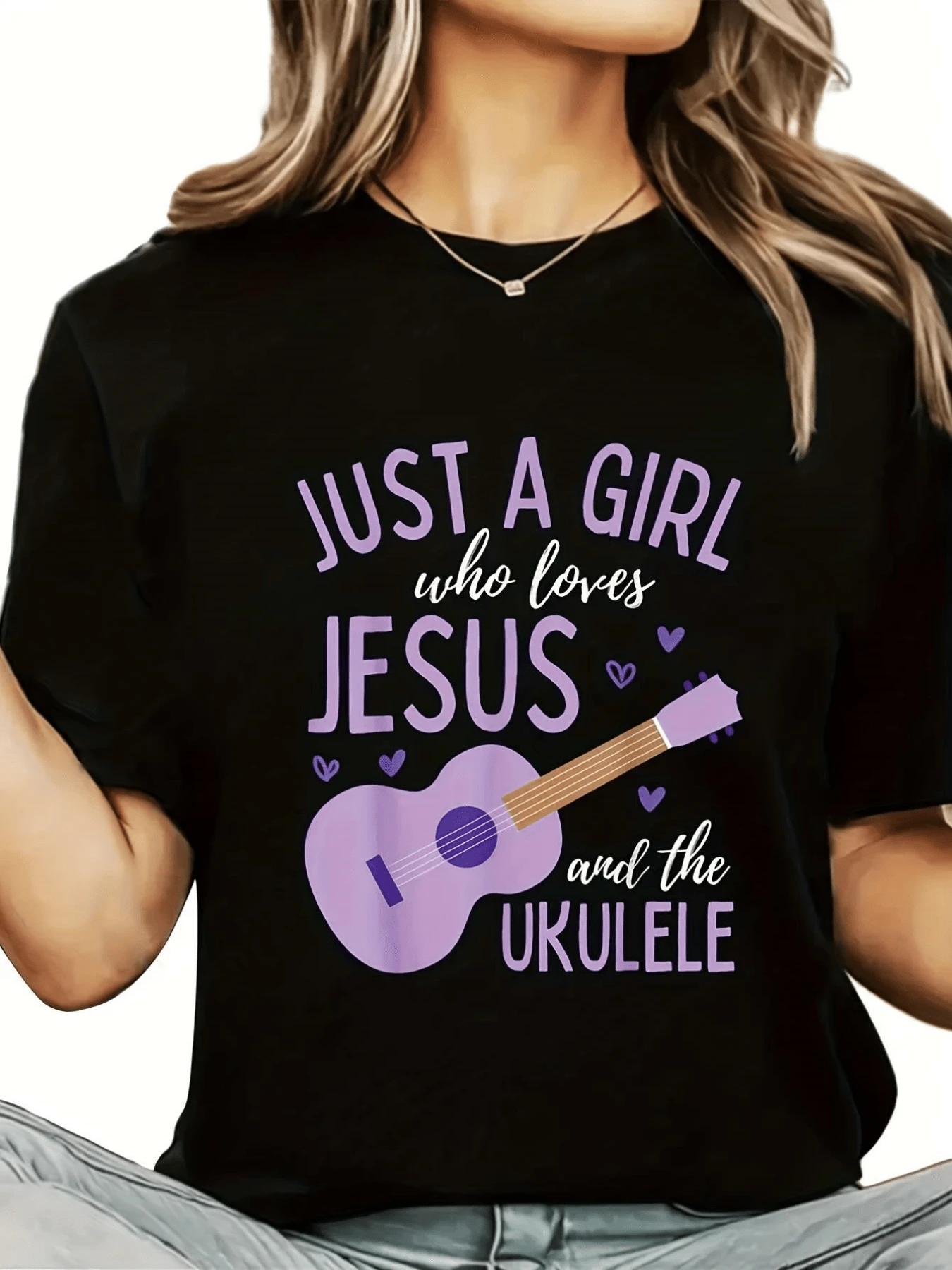A Purple Guitar Surrounded By Hearts Symbolizes Spiritual Love And The Harmony Of Music, Uniting Faith And Passion. A Comfortable, Modern Women's T-Shirt, Perfect For Everyday Wear. - Black - View 1