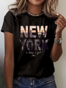 Paisaje urbano de Nueva York con rascacielos brillando al atardecer transmitiendo energía moderna y amor por la gran ciudad camiseta de mujer casual cómoda y versátil para uso diario - Negro - Ver 1