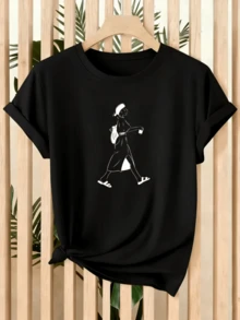 Image Of A Woman Walking Serenely, Holding A Cup And Carrying A Backpack, Symbolizing Freedom, Tranquility, And A Traveler's Spirit. Modern, Comfortable Women's T-Shirt For Everyday Wear. - 黑色 - 查看 1