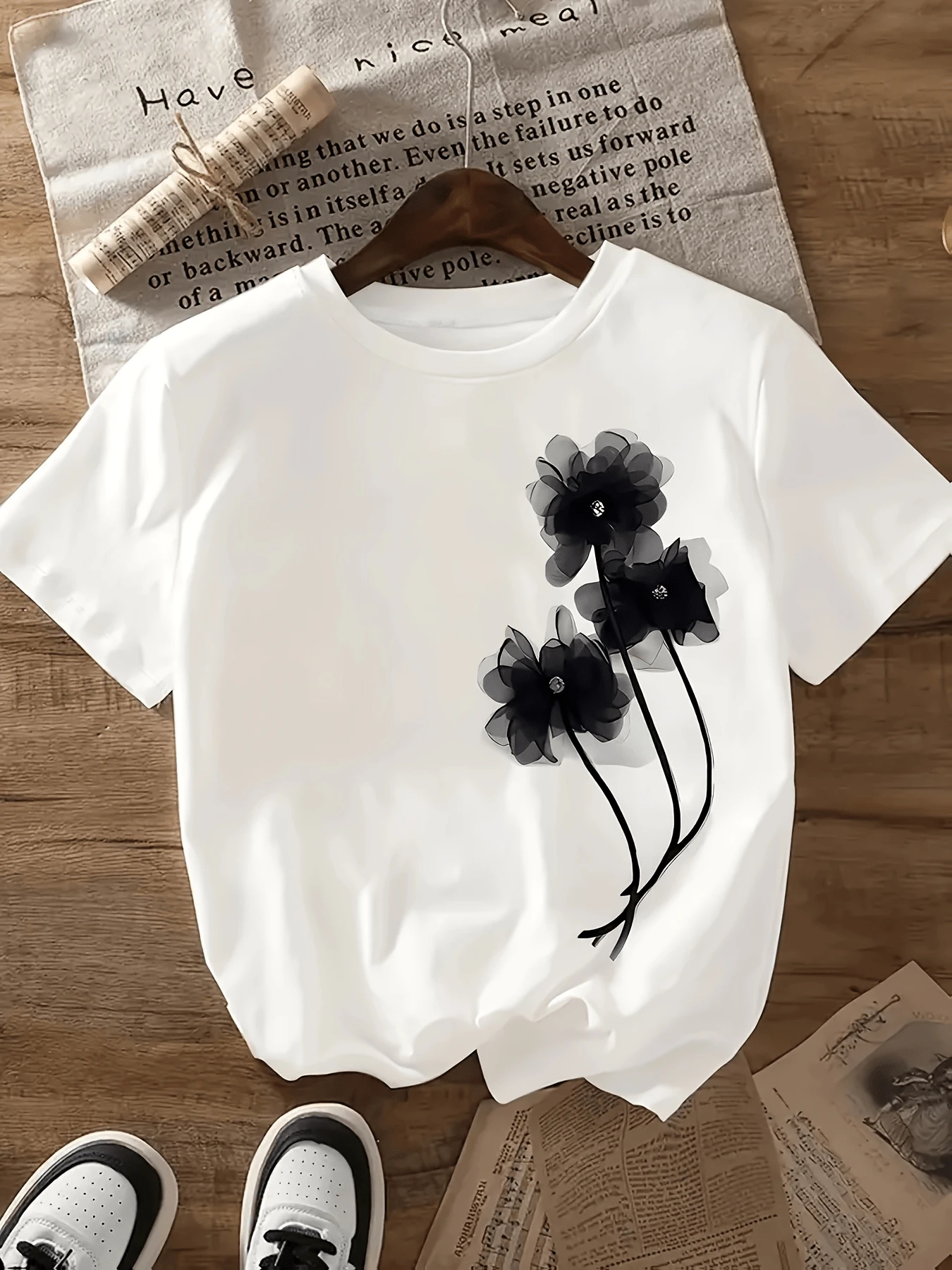 Dark Translucent Flowers Symbolizing Elegance, Serenity, And Strength Grow Subtly Against A Light Background, Reflecting A Modern Artistic Style. This Comfortable And Versatile Women's Casual T-Shirt Is Perfect For Everyday Wear. - 白色 - 查看 1
