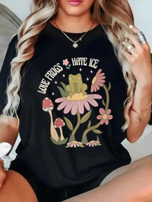 A Cheerful Frog On A Large Pink Flower Surrounded By Mushrooms And Small Flowers Symbolizes Natural Harmony And The Joy Of Living. A Comfortable, Casual Women's T-Shirt For Relaxed Days And Outdoor Adventures. - 黑色 - 查看 1