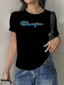 Colorful Word Symbolizing Confidence, Energy, And Overcoming Challenges, Written In Blue Strokes With A Gold Border In The Center On A Solid Background. Modern Casual Women's T-Shirts For Stylish And Comfortable Everyday Wear. - 黑色 - 查看 1