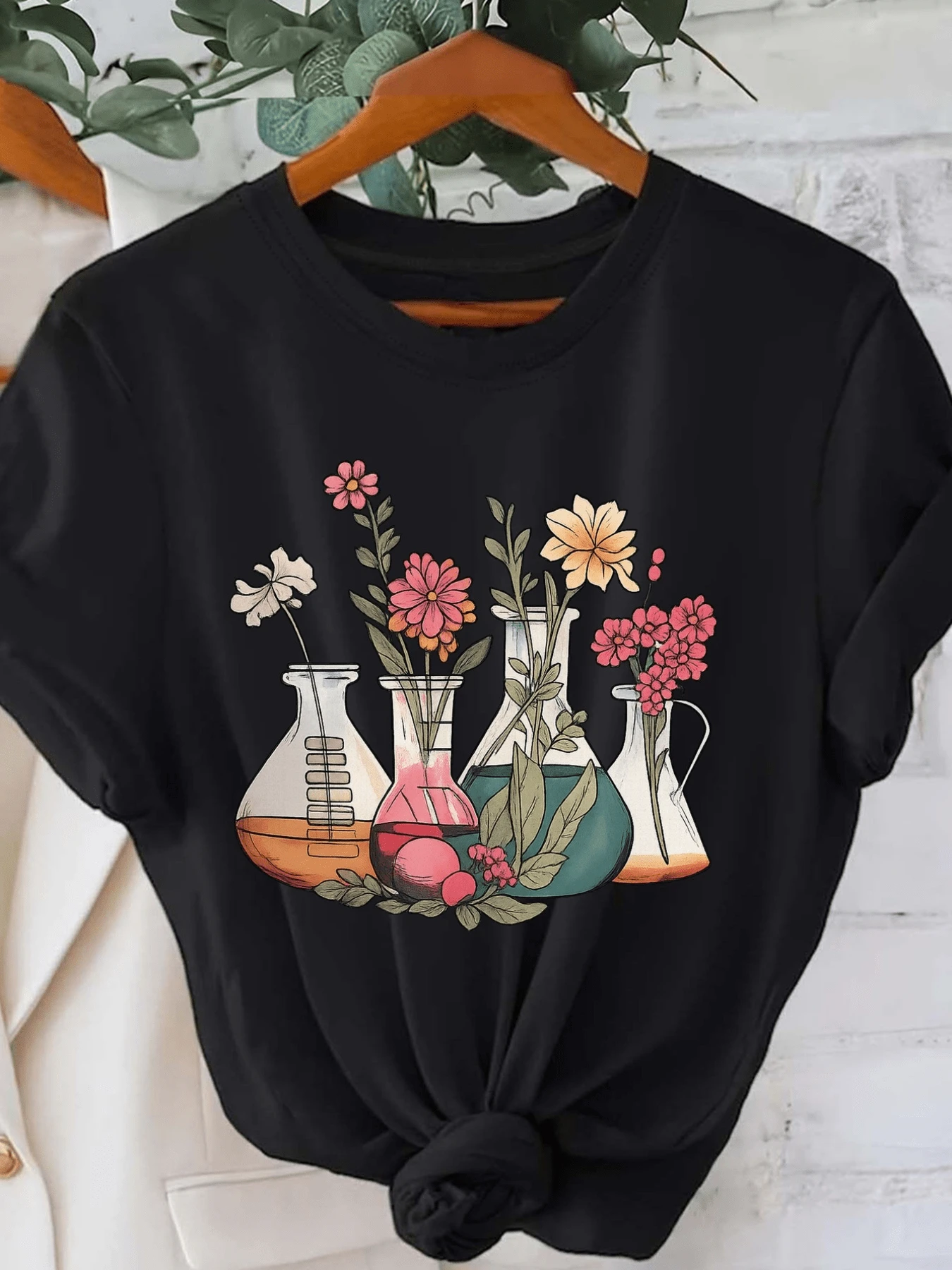 Glass Jars With Colorful Flowers Symbolizing The Union Between Science And Nature, Creating An Atmosphere Of Harmony And Serenity. Women's Casual, Modern, Comfortable T-Shirt For Everyday Wear. - Black - View 1