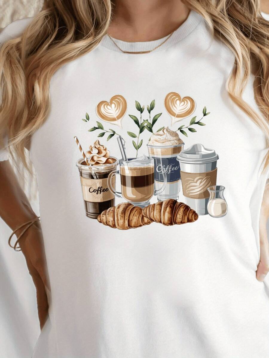 Coffee Cups With Heart-Shaped Foam Art Surrounded By Green Leaves And Croissants Evoke The Warmth Of A Peaceful Morning. Comfortable Casual Women's T-Shirt For Coffee Lovers. - 白色 - 查看 1