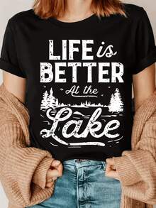 Landscape With Trees And Lake That Conveys Calm And Connection With Nature, Inviting You To Enjoy Quiet Moments And Inner Peace. Casual, Comfortable And Modern Women's T-Shirt For A Relaxed Look. - Black - View 8