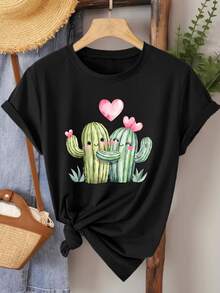 Two Smiling Cacti Embracing With Pink Hearts Symbolize Joyful Love And Sincere Union In A Tender Desert Landscape. This Comfortable Women's Casual T-Shirt Is Ideal For Relaxed Days And Happy Moments. - 黑色 - 查看 1