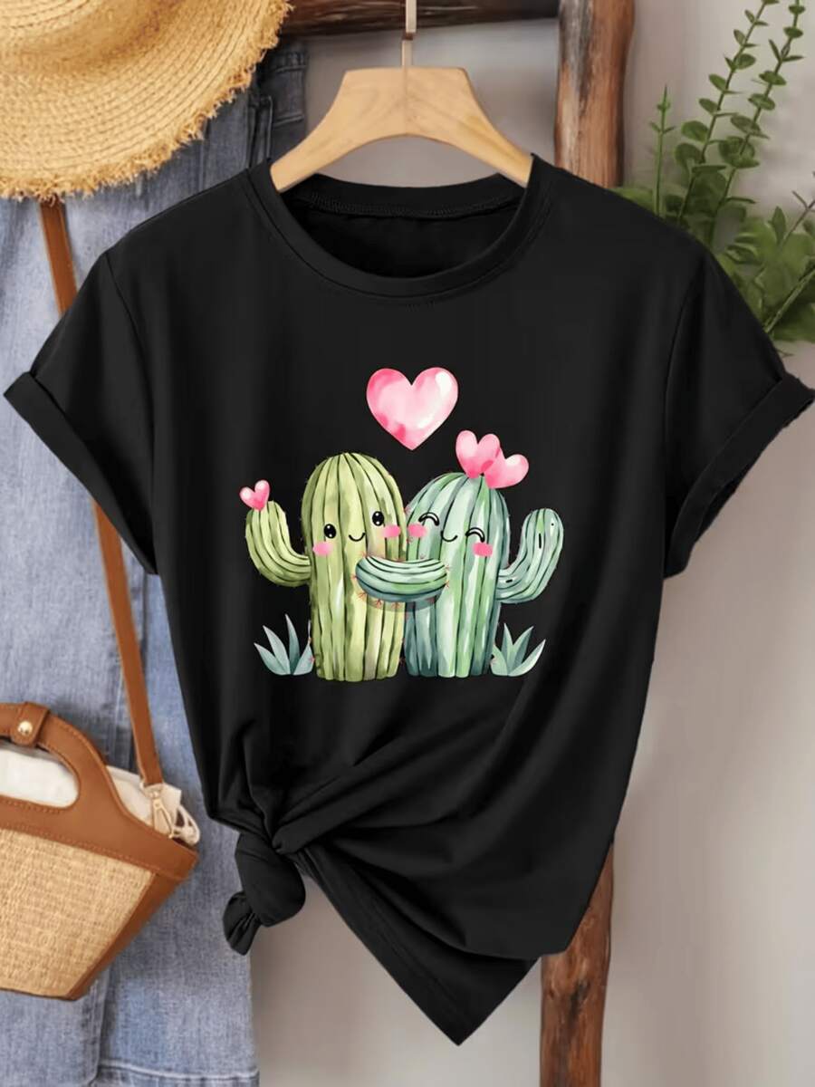 Two Smiling Cacti Embracing With Pink Hearts Symbolize Joyful Love And Sincere Union In A Tender Desert Landscape. This Comfortable Women's Casual T-Shirt Is Ideal For Relaxed Days And Happy Moments. - 黑色 - 查看 1