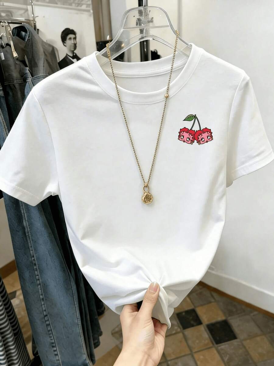 Caricatura juguetona de cerezas con caras adorables y mejillas rosadas vibrantes evoca un espíritu alegre y coqueto perfecto para expresar tu personalidad única y juguetona esta camiseta de mujer es ideal para crear looks divertidos y femeninos. - Blanco - Ver 1