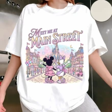 Diseny Minnie & Daisy Meet Me At Main Street Graphic Sweatshirt, Made Of Soft And Thickened Fabric With Cloud-Like Touch, This Crewneck Sweatshirt Features A Sweet Pastel Print Of Minnie Mouse And Daisy Duck Walking Hand In Hand Down Main Street Toward The Magic Castle With Fireworks And Balloons, Decorated With The Quote "Meet Me At Main Street" In Soft Gradient Lettering, Offering A Comfortable Relaxed Fit That Suits Daily Wear, Theme Park Trips, Casual Outings And Girls' Gatherings, Ideal As A Sweet And Thoughtful Gift For Disney Lovers To Add A Touch Of Magic And Warmth To Every Moment. - White - View 1