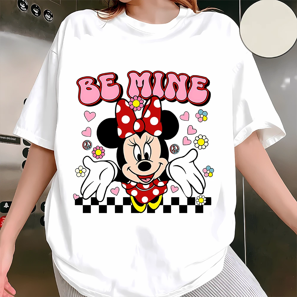 Disney Minnie Mouse "Be Mine" Crew Neck Sweatshirt: This Women's Crew Neck Sweatshirt Features Beloved Disney Character Minnie Mouse In A Sweet Retro-Inspired Design, Perfect For Fans Of The Classic Character. Made With Soft, Thickened Fabric, It Offers A Cloud-Like, Skin-Friendly Feel That Keeps You Warm And Cozy All Day Long. The Front Showcases A Playful Print: Minnie In Her Iconic Red Polka Dot Dress And Bow, Surrounded By Hearts, Flowers, Peace Signs, And The Phrase "BE MINE" In Bubbly Pink Lettering, With A Checkered Border At The Bottom. The Cheerful, Nostalgic Art Style Captures Her Sweet And Playful Spirit Perfectly. Designed With A Relaxed Fit, This Sweatshirt Provides A Comfortable, Flattering Silhouette For All Body Types. It Works Great For Casual Outings, Theme Park Visits, Friend Gatherings, Or Cozy Days In, And Makes A Thoughtful Gift For Any Disney-Loving Fan. - White - View 1