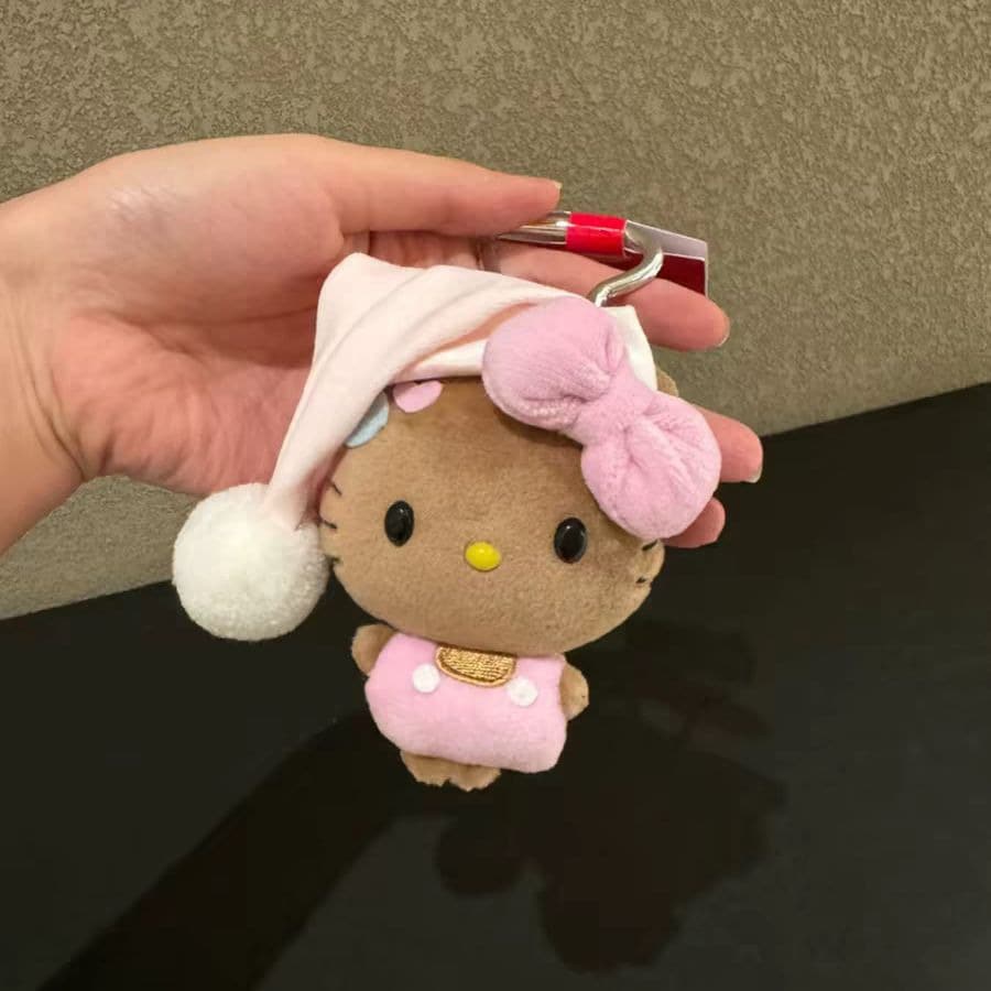 1pc Plush Keychain, Cute Caramel Color KT Cat Sleeping Hat Bag Pendant With Pink Bow, Soft Mini Plush Charm, Gift For Girls