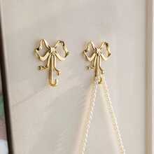 1/2pcs Gold Elegant Bow Metal Wall Hooks, Exquisite Painted Craftsmanship, Sturdy And Durable, No-Drill Convenient Wall Storage, Can Hang Keys, Hats, Clothes, Suitable For Entryway, Living Room, Bedroom, Bathroom, Princess Room Decoration, Simple And Highly Attractive, Home Wall Organization Essential - Multicolor - View 1