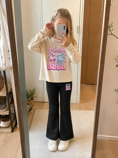 Young Girl Sweet & Cute 2-Piece Set, Apricot Long Sleeve Top Paired With Black Flare Pants, Top Front Printed With Pink & Blue Anthropomorphic Pearl Milk Tea Cup Pattern Surrounded By "JUST A GIRL WHO LOVES BOBA" Pink-Blue Gradient 3D English Slogan And Heart Decoration, Pants Leg Echoing The Same Mini Print Design, Overall Look Full Of Childhood Charm And Style, Loose Casual Versatile, Suitable For Autumn/Winter Layering, Daily Outings And School Wear