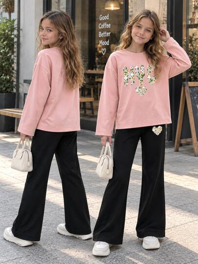 Girls' Cute & Playful 2-Piece Set, Pink Long Sleeve Top Paired With Black Flare Pants, Top Features "NYC" Artistic Lettering Filled With Yellow & White Daisies And Decorated With Matching Floral Heart Patterns, Pants Have Mini Floral Heart Print Detail On Left Leg, Loose Casual Versatile, Suitable For Autumn/Winter Layering, Daily Outings And School Wear